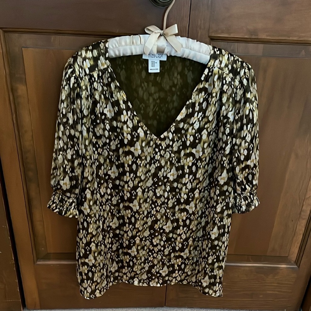 Brown, green and metallic V-neck blouse with short puff sleeves.